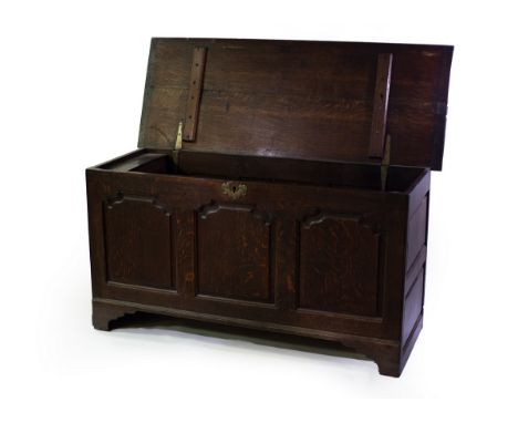 An 18th Century oak coffer, with triple panel front on bracket feet, 147cm wide