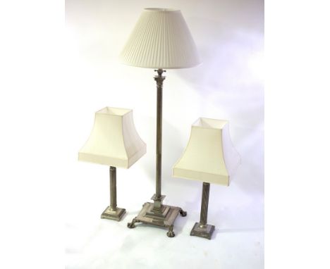 A silvered brass Corinthian column telescopic standard lamp and a pair of silvered table lamps