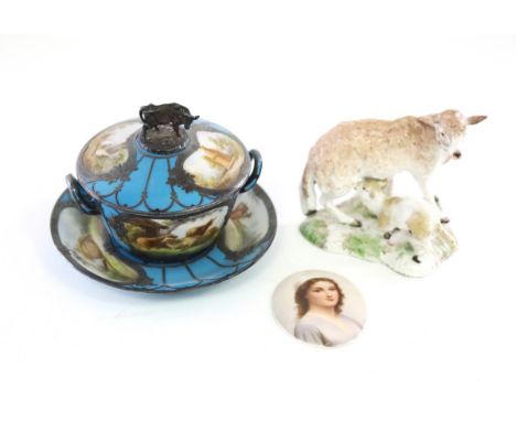 A Sèvres style butter dish, cover and stand with cow finial, a Samson model of a sheep and an oval portrait medallion CONDITI