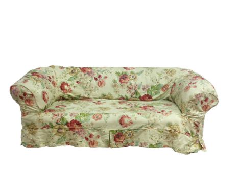 A Victorian upholstered Chesterfield settee with a deep button back on turned front legs, fitted a floral loose cover, 193cm 