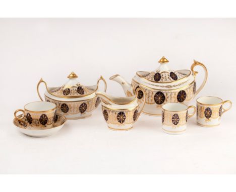 A Grainger &amp; Wood part tea service, circa 1810, pattern No. 179, gilt with a leaf and dot swagged border with blue rosett
