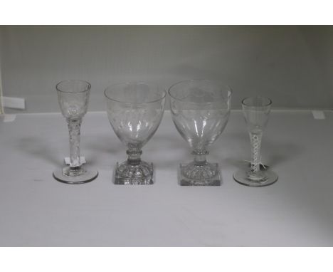 An 18th Century wine glass with faceted stem, 15cm high, another glass, 12.5cm high and two engraved rummers with lemon squee