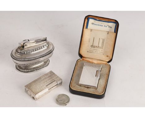 A Dunhill Elite cigarette lighter in an engine turned case with original box, a Dunhill 70 lighter and a Ronson Queen Anne li
