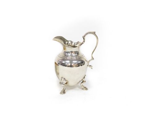 A George II silver jug, maker's mark rubbed, London 1738, of ovoid form with scroll handle and squat legs with stepped feet, 