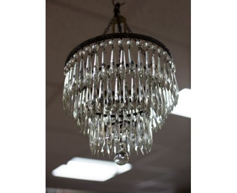 A small glass light fitting, the four graduated circular tiers hung with prismatic drops, 25cm diameter