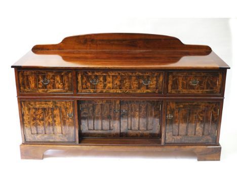 A cherry and pear wood sideboard, fitted three drawers above cupboard doors on bracket feet, 176cm wide 
