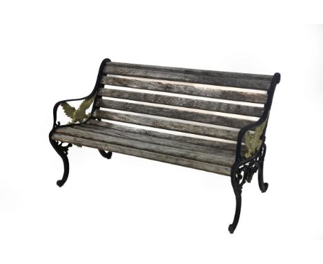 A slatted garden bench, the iron end supports decorated with eagles, 125cm wide