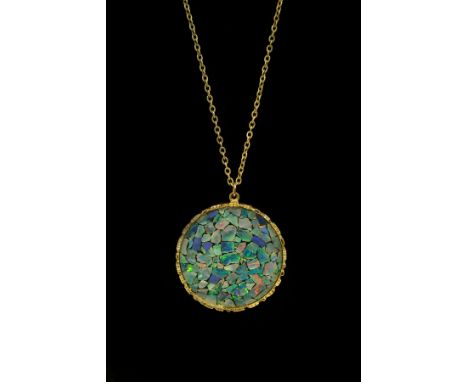 A 9ct yellow gold and opal pendant, maker SI, circa 1975, the circular pendant 4cm diameter on a 9ct yellow gold chain, chain