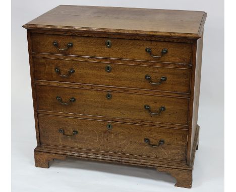 A George III oak chest of four long graduated drawers, on bracket feet, 95cm wide CONDITION REPORT: Top is split in several p