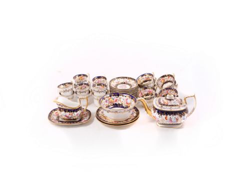 A John Rose Coalport tea set, circa 1820, pattern No. 730, decorated flowers with cobalt blue and gilt bands, comprising teap