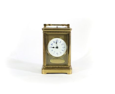 A Victorian gilt brass cased carriage clock, with circular enamel dial and repeat mechanism, 18.5cm high (handle up)