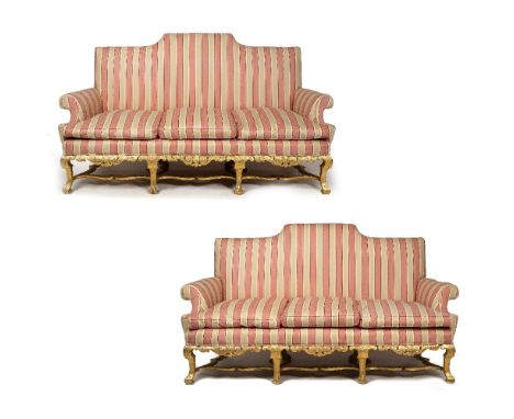 AN ANTIQUE CHIPPENDALE STYLE GILT THREE SEATER SOFA with scroll centred back and arms, striped pink and cream upholstery and 