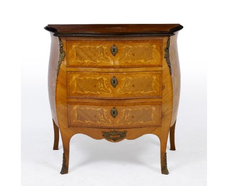 AN 18TH CENTURY FRENCH STYLE WALNUT SERPENTINE COMMODE with marquetry inlay and cast metal mounts, 82cm wide x 42.5cm deep x 