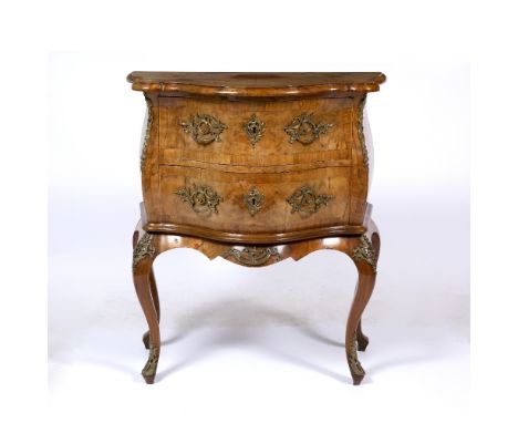 AN 18TH CENTURY STYLE WALNUT SERPENTINE TWO DRAWER COMMODE with gilt metal mounts and cabriole legs, 73cm wide x 41.5cm deep 