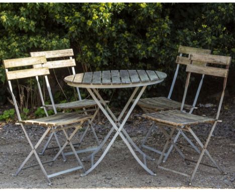 A SLATTED TEAK CIRCULAR CAFE TABLE with folding metal base, 76cm diameter x 70cm high together with four matching chairs