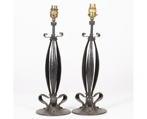 A PAIR OF EARLY 20TH CENTURY ART NOUVEAU BLACK PAINTED WROUGHT IRON TABLE LAMPS with styalised foliate decoration and circula