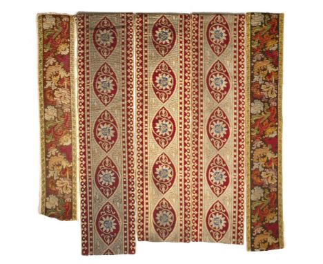 A SET OF THREE OLD HANGING WOOLEN NEEDLEWORK PANELS centrally decorated with passion flowers within a banded border, each pan