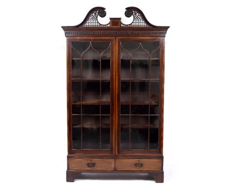 AN ANTIQUE MAHOGANY FLOOR STANDING BOOKCASE with pierced swan neck cresting, astragal glazed doors with cross banded decorati