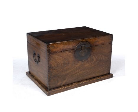 AN ORIENTAL HARDWOOD BOX OR TRUNK with metal lock plate and carrying handles to the side, 83.5cm long x 55.5cm deep x 55cm hi