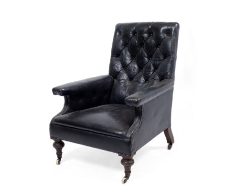 A VICTORIAN LEATHER UPHOLSTERED DEEP ARMCHAIR with button back, turned front legs and ceramic casters, 71cm wide x 76cm deep 