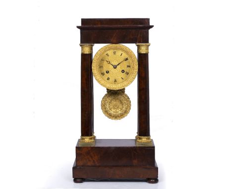 A 19TH CENTURY FRENCH MAHOGANY PORTICO MANTEL CLOCK with gilt engine turned Roman dial, twin train drum movement with outside