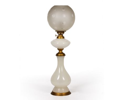 AN ANTIQUE WHITE GLASS TABLE LAMP with etched cut glass shade decorated with stars, 64.5cm high