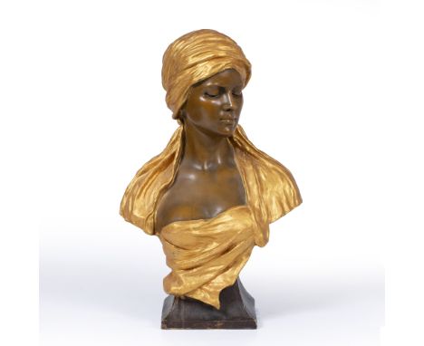 A LATE 19TH CENTURY CONTINENTAL POTTERY BUST by Goldscheider, the girl wearing a gilt head dress, the bust stamped 1340/329/5