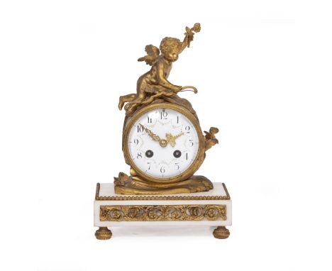 A LATE 19TH CENTURY FRENCH ORMOLU AND MARBLE MANTLE CLOCK the drum case surmounted by cupid holding his bow, the enamel dial 