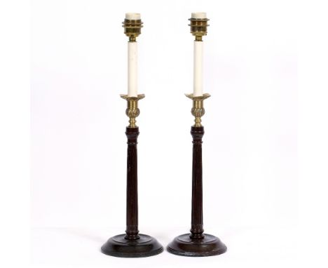 A PAIR OF GEORGIAN STYLE MAHOGANY TABLE LAMPS with fluted stems and circular spreading bases, 14cm diameter at the base x 54.