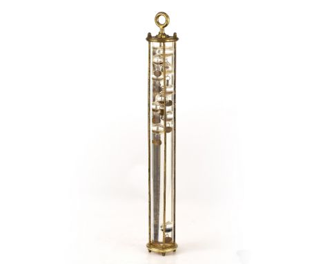 A GALILEO THERMOMETER with a series of glass bubbles in a tube in a lacquered brass frame, the tube 5cm diameter and frame 57