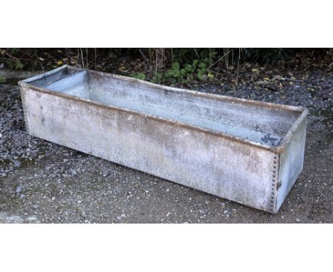 AN OLD GALVANIZED RECTANGULAR WATER TROUGH OR PLANTER of riveted construction, 184cm long x 49cm deep x 39cm high
