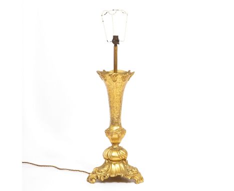 AN ORMOLU TABLE LAMP with flaring octagonal stem and scrolling tripod base, 64cm high to the top of the light fitting