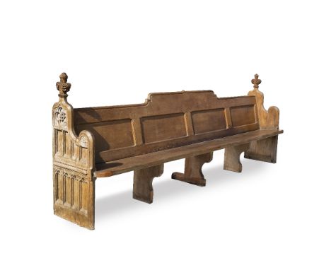 A PAIR OF 19TH CENTURY OAK PEWS with Gothic tracery decorated ends, surmounted by fleur de lis finials and with shaped panel 