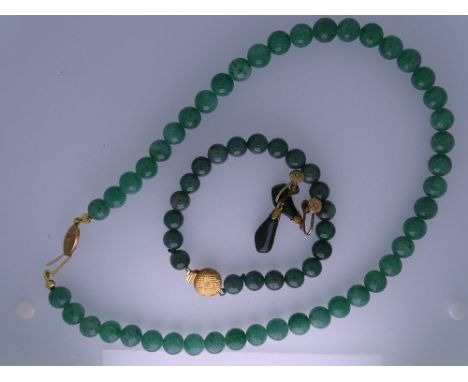 A JADE NECKLACE ENSEMBLE - a dark green jade bead necklace with yellow metal, believed nine carat gold clasp, a similar brace