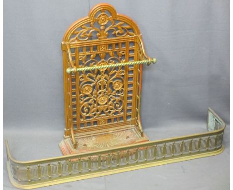 VICTORIAN CAST IRON STICK STAND and a brass fender, the stand with pierced floral detail, brass twist front rail and removabl