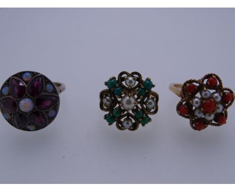 THREE DRESS RINGS - 1.a nine carat gold with floral seven coral and six pearl setting, 4.5 grms, size L/M - 2. a nine carat g