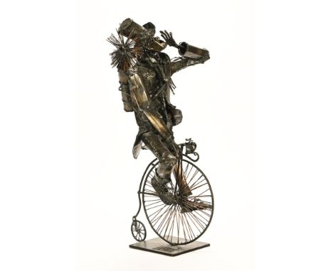 A scratch built metalwork sculpture, modelled as a chimney sweep on penny farthing.  Height 61 cm.
