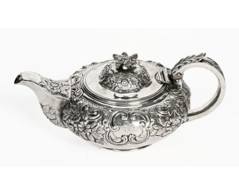 A George IV Irish silver teapot, repousse with foliate scroll work, Dublin mark 1826, maker Edward Crofton.  739 grams.  (see