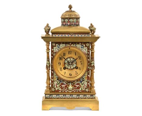 A 19th century French brass champleve enamel mantel clock, with finial decoration over pillar supports containing a circular 