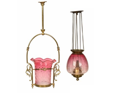 An early 20th century hanging light fitting in brass with cranberry and floral etched flared shade. +/- 82 cm long, and hangi
