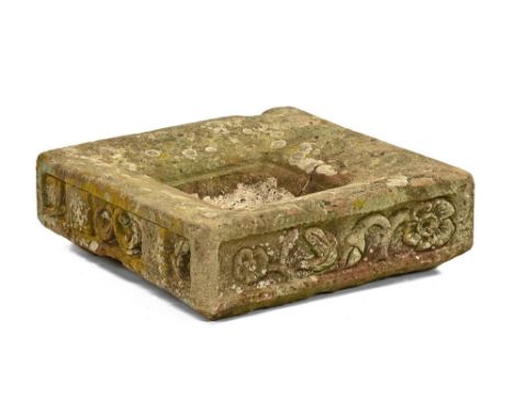 A stone trough of square form, each side with carved floral motifs.  54 cm wide, 17 cm high.  (see illustration).