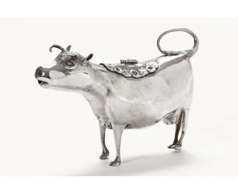 A silver cow creamer of traditional form, with hinged cover with tail and bee motif, London 1881. 15 cm long, +/- 183 grams. 