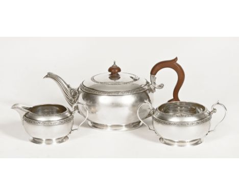 A George V silver three piece tea service, Birmingham 1929, maker Docker & Burn Limited.  1039 grams.