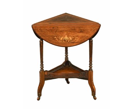 A late Victorian rosewood and inlaid triangular table with three drop flaps, with low shelf and raised on castors.  Height 71