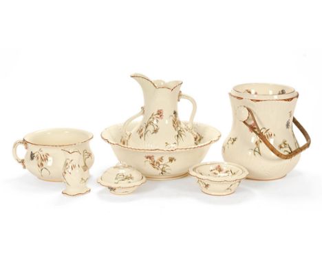 An Edwardian ceramic bathroom set, makers mark Jones & Sons, Cornflower Reg. No. 393348, comprising a pale wash jug, basin, t