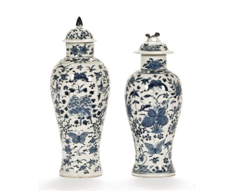 Two Chinese blue and white lidded baluster vases, of Kangxi style, 19th century with bird and butterfly amidst foliage decora