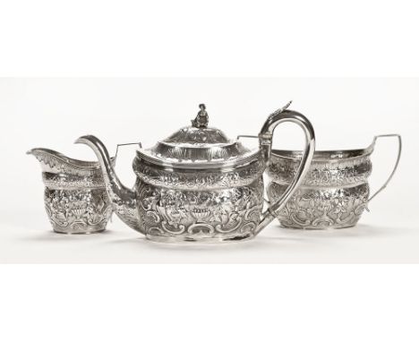 A George III silver rococo style teapot, embossed with foliate scroll decoration and with ivory insulators to the handle, Lon