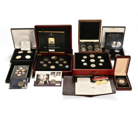 A collection of cased sets of coins, including "The Great Britain Five Shilling Crown Collection" (162/499), The London Mint 