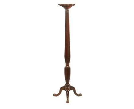 A 19th century mahogany jardiniere stand, with reeded column and tripod base on pad feet.  142 cm high.   CONDITION REPORT:  