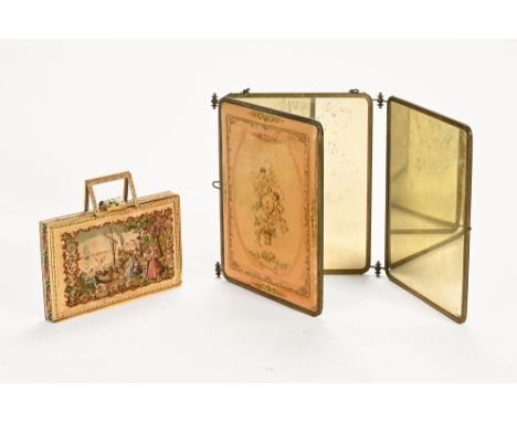 A 19th century French tri-fold vanity mirror, having lacquered printed decoration depicting floral bouquet and cherubs with a
